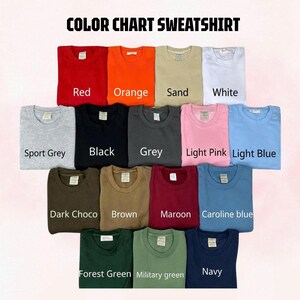 May include: A color chart for sweatshirts featuring fifteen crewneck garments in various colors labeled as Red, Orange, Sand, White, Sport Grey, Black, Grey, Light Pink, Light Blue, Dark Choco, Brown, Maroon, Caroline blue, Forest Green, Military green, and Navy.