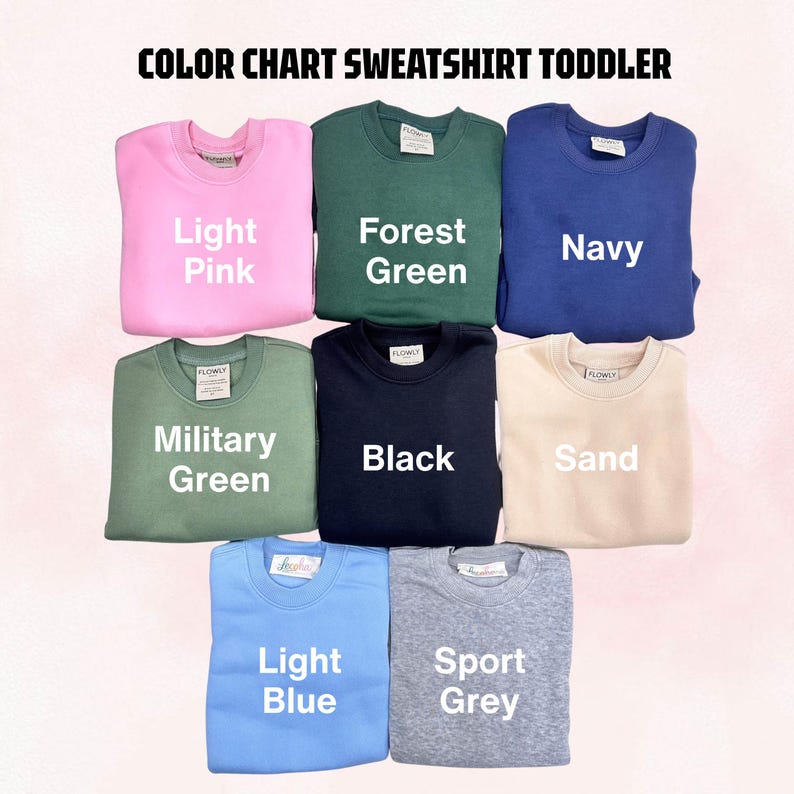 May include: A color chart for toddler sweatshirts featuring eight crewneck pullovers in light pink, forest green, navy, military green, black, sand, light blue, and sport grey. Each sweatshirt is labeled with its corresponding color name in white text.