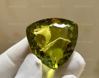 Piedra preciosa suelta de vidrio color peridoto verde claro de 90 quilates, forma trillón, sin inclusiones visibles a simple vista.