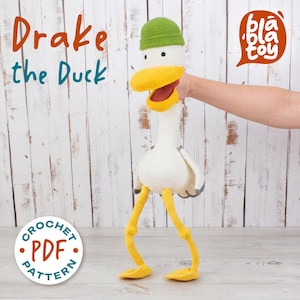 May include: A handmade crochet duck toy named "Drake the Duck" with a yellow beak, legs, and feet, a green hat, and a white body. The text "Drake the Duck" is displayed in orange and teal. The image also includes the text "Crochet PDF Pattern".