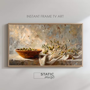 Può includere: Dipinto di natura morta incorniciato con una ciotola di terracotta piena di olive verdi, rami di ulivo e un panno bianco drappeggiato. L'opera d'arte ha una tavolozza di colori neutri con il testo "INSTANT FRAME TV ART" e "STATIC muse".