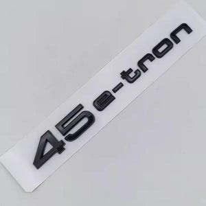 May include: Black 45 e-tron emblem on a white rectangular sticker. The emblem features the numbers "45" followed by "e-tron" in a bold, sans-serif font. The sticker is set against a light gray background.