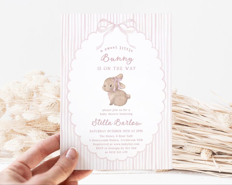 May include: A baby shower invitation with a pink and white striped background. The invitation features a watercolor illustration of a bunny with a pink bow. Text includes "a sweet little Bunny is on the way" and event details.