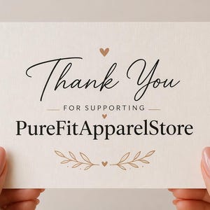 May include: A cream-colored card with the words "Thank You" in elegant script, followed by "FOR SUPPORTING" and "PureFitApparelStore" in a serif font. The card is decorated with small hearts and leaf accents.