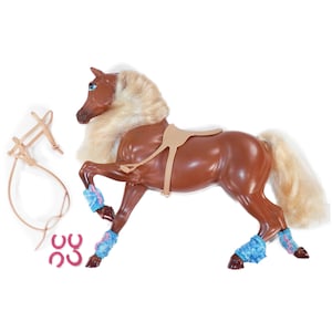 May include: A brown toy horse with a tan saddle, bridle, and blue leg wraps. The horse has a blonde mane and tail, and pink horseshoes are included. The toy is designed for imaginative play and is suitable for children.