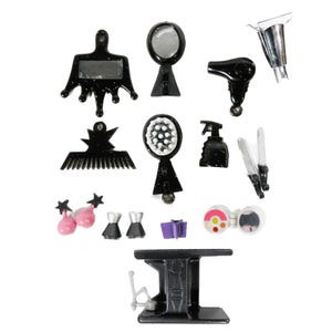 May include: A collection of miniature black beauty salon tools and accessories, including a comb, mirror, hair dryer, and curling iron. Also includes pink star-shaped earrings, dress-shaped charms, and a purple gift box.