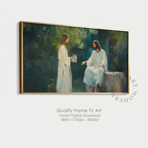 以下が含まれることがあります： 額装されたデジタルアートプリントは、緑と青の背景に白いローブを着た2人の人物が登場する宗教的なシーンを描いています。一人は座っており、もう一人は立って容器を持っています。フレームは金色です。下部のテキストは「Quality Frame TV Art」と書かれています。