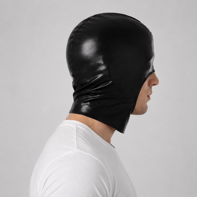 May include: A black hood made of a smooth, shiny material that covers the head and neck, featuring a large open cutout for the face. The hood has a fitted design with visible seams along the top and sides, providing full head coverage.