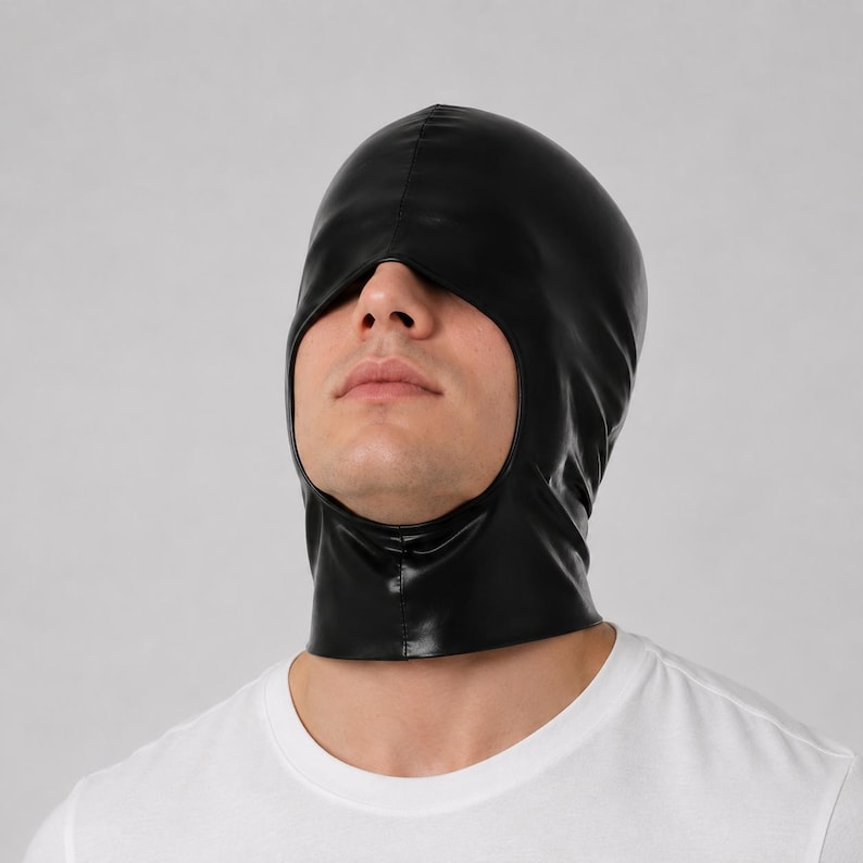 May include: A black hood made of a smooth, shiny material that covers the head and neck, featuring a single large opening for the eyes, nose, and mouth area. The hood has a central seam running vertically from the forehead to the crown.