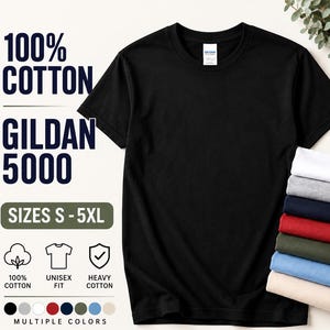 May include: A black short-sleeved t-shirt with a crew neckline, labeled Gildan 5000. The text reads 100% Cotton, Gildan 5000, and Sizes S-5XL. A stack of folded t-shirts in white, gray, navy, red, olive, light blue, and beige is visible on the right.