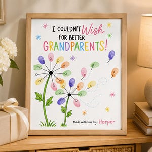 May include: A framed print featuring the text I COULDN'T WISH FOR BETTER GRANDPARENTS! in black, pink, and rainbow colors. The design includes two dandelion illustrations with colorful fingerprint petals and the text Made with love by: Harper.
