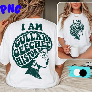 May include: White t-shirt with the text "I AM GULLAH GEECHEE HISTORY" in dark green. The design features a profile of a woman with decorative facial markings and a large afro. The shirt is visible on a person from the back and front.