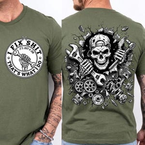 May include: Olive green t-shirt with a front graphic that reads "I FIX SHIT, THAT'S WHAT I DO" with a skeleton hand holding a wrench. The back graphic features a skull wearing a cap, holding wrenches, surrounded by engine parts.