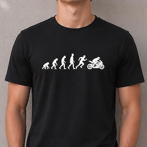 May include: A black short-sleeved t-shirt featuring a white graphic print that depicts the evolution of humanity, starting with a primate and progressing through various stages to a human riding a motorcycle, centred on the chest area.