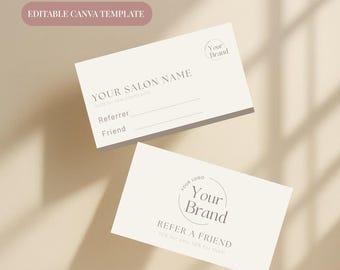 May include: Two cream-colored business cards with text. The top card reads "YOUR SALON NAME" and "Referrer" and "Friend". The bottom card says "REFER A FRIEND" and "Your Brand". A pink rectangle says "EDITABLE CANVA TEMPLATE".