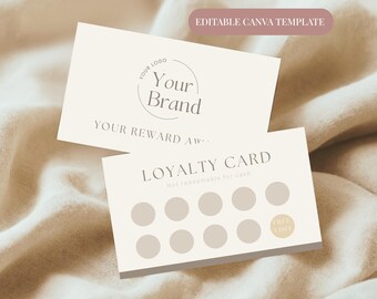 May include: Two cream-colored loyalty cards with text and a logo. One card displays "Your Brand" in a circle, and "Your Reward". The other card reads "Loyalty Card" and "Free Visit". The cards are on a beige fabric.