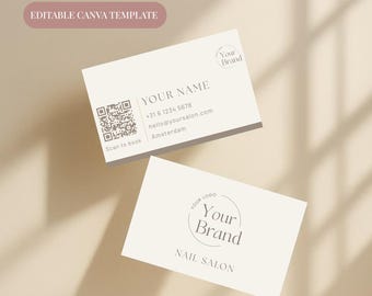 May include: Two cream-colored business cards with text and a QR code. One card reads "YOUR NAME" with contact information and "Amsterdam" below. The other card says "NAIL SALON" and "Your Brand" in a circle. The top left corner says "EDITABLE CANVA TEMPLATE".