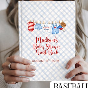 May include: A baby shower guest book with a blue and white gingham pattern. The cover features a clothesline with baby clothes and baseball-themed items. The text reads "Madison's Baby Shower Guest Book" and "August 8th 2026". The word "BASEBALL" is at the bottom.