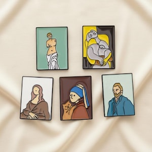 May include: Five rectangular enamel pins featuring famous artworks. The pins depict Venus de Milo, Picasso's Weeping Woman, the Mona Lisa, Vermeer's Girl with a Pearl Earring, and Van Gogh. Each pin has a black border and a unique color palette.