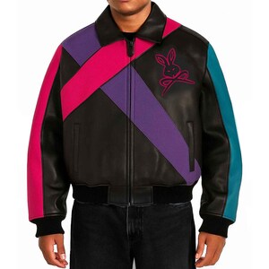 May include: A black leather jacket featuring a front zipper closure, a fold-down collar, and ribbed cuffs and hem. The design includes diagonal color-blocked panels in bright pink and purple, with a teal stripe on the sleeve and a rabbit logo.