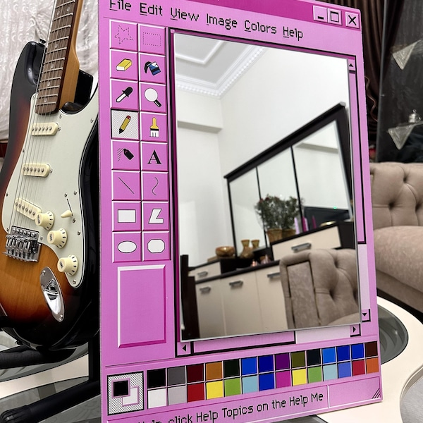 May include: A pink mirror designed to resemble a classic computer Paint window. The mirror features a frame with a color palette, icons, and the text "untitled - Paint". A guitar is visible in the background.