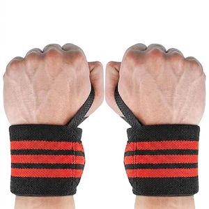 May include: A pair of black and red wrist wraps, suitable for weightlifting. Each wrap has three horizontal red stripes on a black base. The wraps are shown on clenched fists. Ideal for gym workouts.