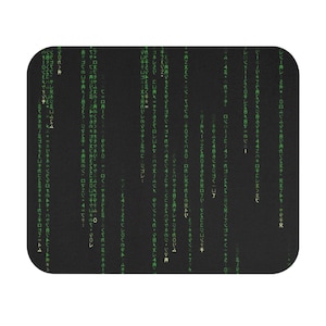 May include: Black rectangular mousepad featuring a green digital rain design, reminiscent of computer code. The design is a repeating pattern of green characters on a black background, creating a tech-inspired aesthetic.