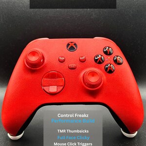 May include: A red Xbox controller with white detailing, branded with the Control Freakz logo and performance build text. Features include TMR thumbsicks, full face clicky buttons, mouse click triggers, and mouse click back buttons.
