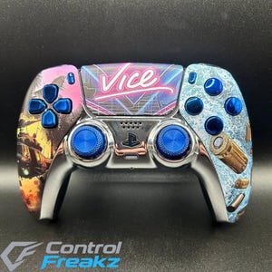 May include: Custom PlayStation 5 controller with a chrome finish. The controller has blue thumbsticks and buttons, with the word "Vice" in neon pink. The sides feature a tropical sunset and bullet casings.