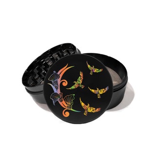 May include: Black grinder with a colorful floral design and birds. The grinder has a black lid with a screen.