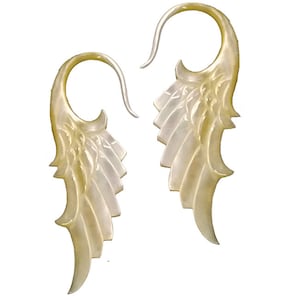 May include: A pair of iridescent, wing-shaped earrings. The earrings have a curved hook design and a layered, feather-like appearance. The color is a pearlescent white with subtle variations.
