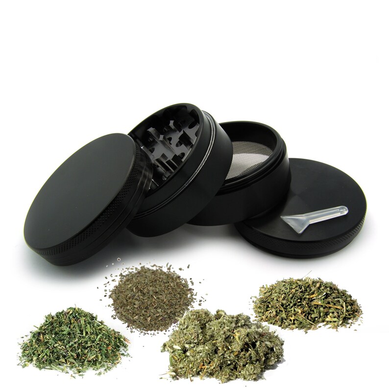 May include: A black four-piece grinder with a screen and a scraper. The grinder is open and there are three piles of dried herbs.
