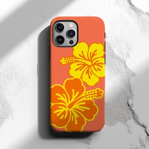 May include: Coral-colored phone case featuring two hibiscus flower designs in yellow and orange. The case has a glossy finish and is designed to fit a smartphone. The floral pattern is a tropical design.