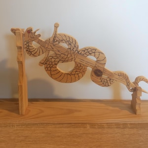 May include: A white ceramic mug with a black handle and the text "But First, Coffee" in a handwritten style. The mug is on a white surface. The mug is approximately 4 inches tall.