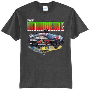 May include: Dark gray t-shirt featuring a race car design with the text "THE INTIMIDENTE" in red, green, and white. The car has the number 77 and the words "Ride Dente" on it. The number 3 is reflected below the car.