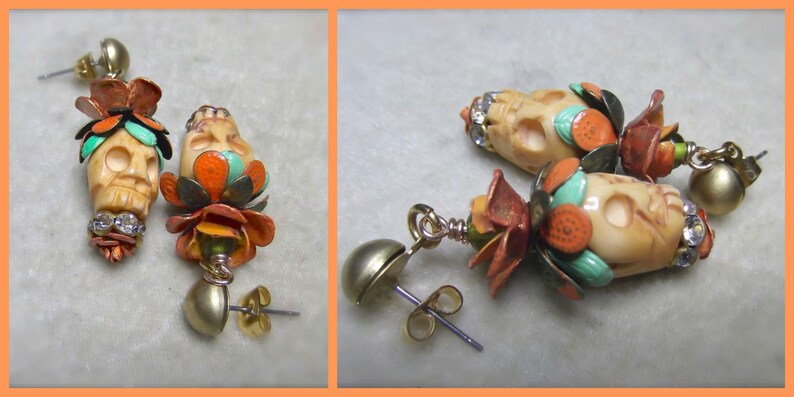 May include: A pair of skull-shaped earrings with colorful floral accents. The earrings are made of bone and feature a mix of turquoise, orange, and white colors. The earrings are attached to gold-toned ear wires.