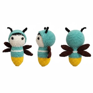 May include: A handmade crochet toy in the shape of a stylized firefly. The toy features a teal body with white stripes, a yellow bottom, and brown wings. It has a teal hood with black antennae and white eyes.