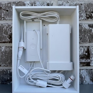 May include: A white rectangular organizer box containing a Govee smart controller and a power adapter. The unit features a white power cord with a connector, a control module with a power button, and a secondary white power brick component.