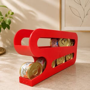 May include: A bright red plastic can dispenser rack featuring two horizontal tiers designed to hold multiple round metal food cans. The structure has an open-sided design, allowing for easy access to the cans stored within the stacked rows.