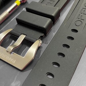 May include: A rustic wooden sign with the text "Welcome to our home" in white lettering. The sign features a distressed finish and a simple, inviting design, perfect for entryway decor.