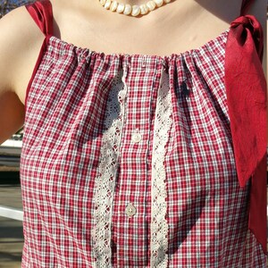 Sleeveless drawstring top, red and white with black.
