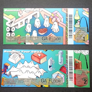 May include: Two colorful concert tickets for a summer tour. The tickets are for the GA floor, with the dates and times of the concerts listed. The tickets are numbered 1 and 2.