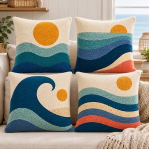 May include: Four square throw pillows featuring textured tufted designs of suns and ocean waves in shades of cream, yellow, light blue, dark blue, and orange. Each pillow displays a unique arrangement of these coastal elements on a soft fabric.