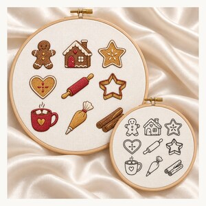 May include: Two wooden embroidery hoops containing white fabric. The larger hoop features colorful embroidered holiday baking icons including a gingerbread person, house, star, heart, rolling pin, mug, piping bag, and cinnamon sticks. The smaller hoop shows the same designs in black outline.