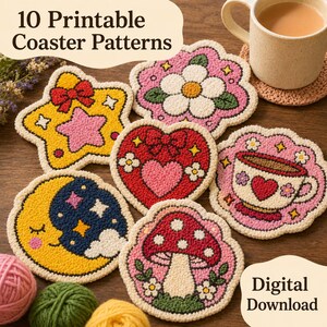 May include: A collection of ten printable coaster patterns in various shapes, including a star, heart, and mushroom, with colorful designs. The coasters are displayed on a wooden surface, alongside a mug of tea and yarn.