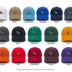May include: A collection of baseball caps in various colors, including white, khaki, and royal blue. Each cap features an embroidered design. The image text reads "White", "Khaki", "Columbia Blue", "Royal Blue", "Navy", "Vintage Navy", "Charcoal", "Black", "Kelly Green", "Dark Green", "Gold", "Orange", "Red", "Cardinal Red", "Maroon", and "Purple".