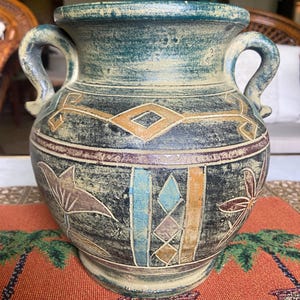 May include: A rustic wooden sign with the text "Welcome to our home" in white lettering. The sign features a distressed finish and a simple, inviting design, perfect for a front porch or entryway.