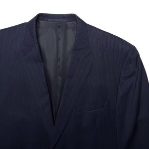 May include: A navy blue pinstripe suit jacket. The jacket has a notched lapel, a chest pocket, and a two-button closure. The fabric has a subtle vertical stripe pattern.