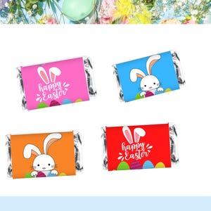 May include: Four colorful candy bar wrappers with Easter-themed designs. Each wrapper features a different color: pink, blue, orange, and red. The wrappers have a white bunny graphic and the words "Happy Easter".