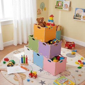 May include: A children's playroom with a stack of colourful storage boxes in orange, green, white, blue, purple, and pink. The boxes are filled with toys, including a teddy bear, building blocks, and toy cars. A wooden train track and a round rug with a star pattern are also visible.